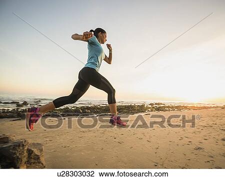USA, California, Newport Beach, Woman jogging on beach View Large Photo Image Stock Image - USA, California, Newport Beach, Woman jogging on beach. Fotosearch