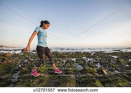 USA, California, Newport Beach, Woman exercising on beach View Large Photo Image Stock Photo - USA, California, Newport Beach, Woman exercising on beach. Fotosearch