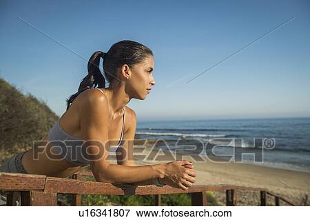 USA, California, Newport Beach, Woman in sport suit looking at sea View Large Photo Image Stock Photo - USA, California, Newport Beach, Woman in sport suit looking at sea. Fotosearch