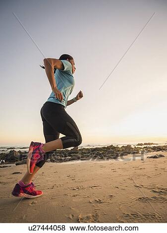 USA, California, Newport Beach, Woman jogging on beach View Large Photo Image Stock Photo - USA, California, Newport Beach, Woman jogging on beach. Fotosearch