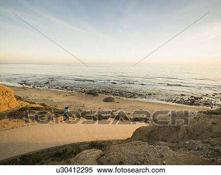 USA, California, Newport Beach, Woman running along footpath View Large Photo Image Stock Photography - USA, California, Newport Beach, Woman running along footpath. Fotosearch