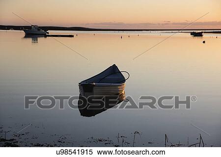 USA, Massachusetts, Cape Cod, Chatham, Boat reflecting in water at dawn View Large Photo Image Stock Photography - USA, Massachusetts, Cape Cod, Chatham, Boat reflecting in water at dawn. Fotosearch