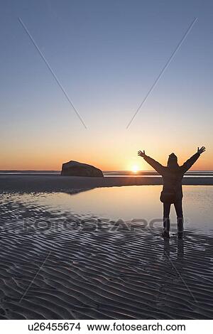 USA, Massachusetts, Cape Cod, Orleans, Man watching sunset at beach View Large Photo Image Picture - USA, Massachusetts, Cape Cod, Orleans, Man watching sunset at beach. Fotosearch