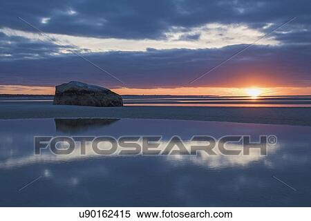USA, Massachusetts, Cape Cod, Orleans, Rock reflecting in sea at sunset View Large Photo Image Stock Photography - USA, Massachusetts, Cape Cod, Orleans, Rock reflecting in sea at sunset. Fotosearch