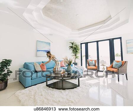 Woman decorating living room View Large Photo Image Stock Image - Woman decorating living room. Fotosearch