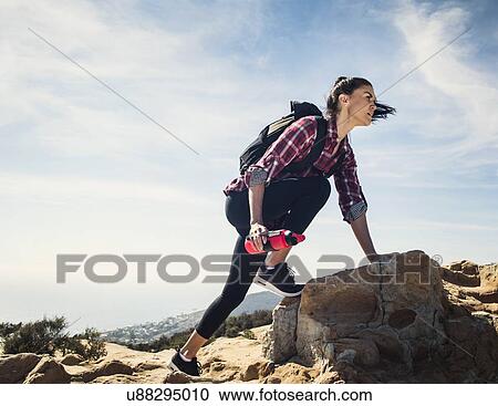 Woman hiking over rocks View Large Photo Image Stock Image - Woman hiking over rocks. Fotosearch