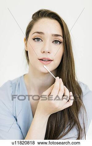 Woman holding cotton bud View Large Photo Image Stock Photo - Woman holding cotton bud. Fotosearch