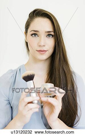 Woman holding powder and make up brush View Large Photo Image Stock Image - Woman holding powder and make up brush. Fotosearch