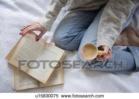 Woman in bed with coffee and book View Large Photo Image Stock Photography - Woman in bed with coffee and book. Fotosearch