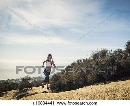 Woman jogging on mountain View Large Photo Image Stock Image - Woman jogging on mountain. Fotosearch