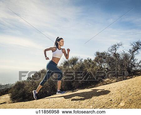 Woman jogging on mountain View Large Photo Image Stock Photo - Woman jogging on mountain. Fotosearch