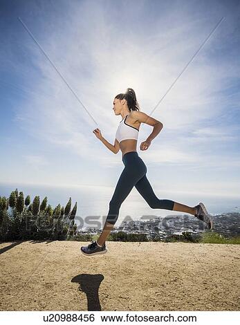 Woman jogging on mountain View Large Photo Image Stock Photograph - Woman jogging on mountain. Fotosearch
