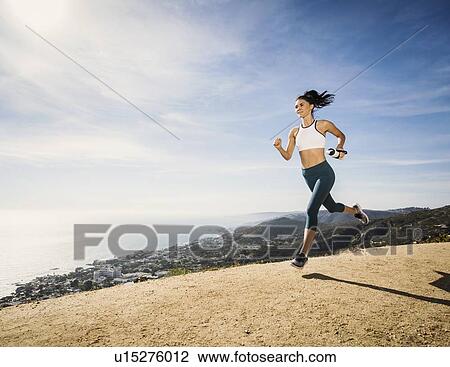 Woman jogging on mountain with water bottle View Large Photo Image Stock Image - Woman jogging on mountain with water bottle. Fotosearch