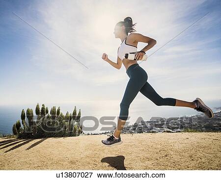 Woman jogging on mountain with water bottle View Large Photo Image Stock Photo - Woman jogging on mountain with water bottle. Fotosearch
