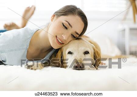 Woman lying on bed with dog View Large Photo Image Stock Image - Woman lying on bed with dog. Fotosearch