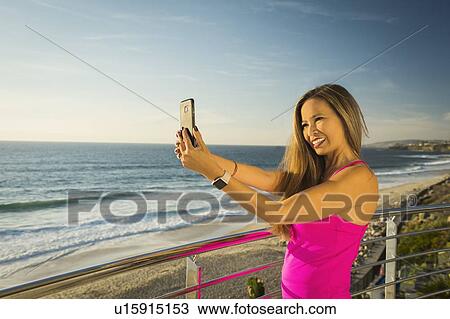 Woman taking selfie View Large Photo Image Stock Image - Woman taking selfie. Fotosearch