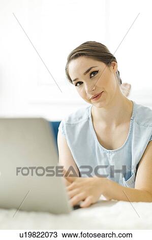 Stock Image - Woman using laptop. Fotosearch