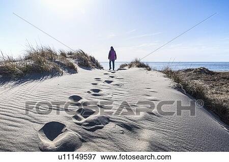 Woman walking on sand View Large Photo Image Stock Photo - Woman walking on sand. Fotosearch