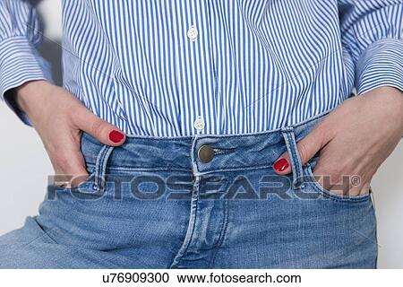 Stock Image - Woman with hands in pockets. Fotosearch