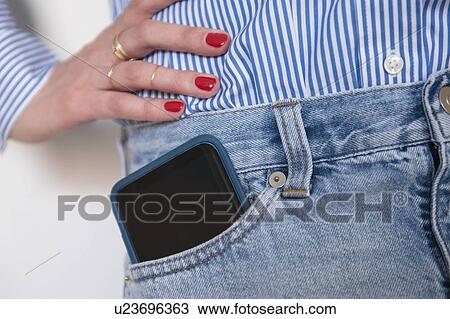 Woman with smartphone in jeans pocket View Large Photo Image Stock Image - Woman with smartphone in jeans pocket. Fotosearch