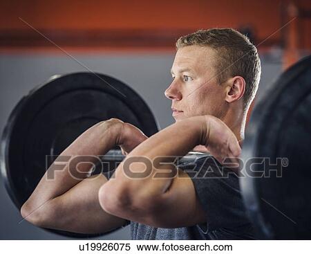 Young man weight lifting View Large Photo Image Stock Photography - Young man weight lifting. Fotosearch