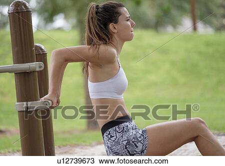 Young woman exercising in park View Large Photo Image Stock Image - Young woman exercising in park. Fotosearch