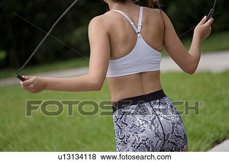 Young woman exercising with jump rope View Large Photo Image Stock Photo - Young woman exercising with jump rope. Fotosearch