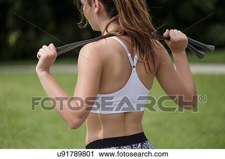 Young woman holding jump rope View Large Photo Image Stock Image - Young woman holding jump rope. Fotosearch