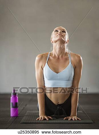 Young woman practicing yoga View Large Photo Image Stock Photography - Young woman practicing yoga. Fotosearch