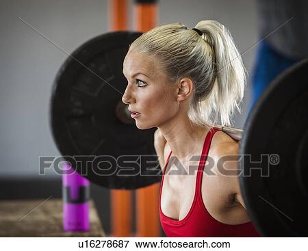 Young woman weight lifting View Large Photo Image Stock Photo - Young woman weight lifting. Fotosearch