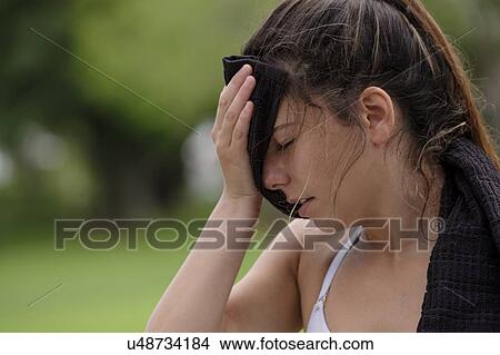 Young woman wiping sweat with towel View Large Photo Image Picture - Young woman wiping sweat with towel. Fotosearch