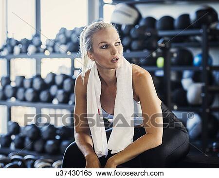 Young woman with towel in gym View Large Photo Image Stock Photography - Young woman with towel in gym. Fotosearch