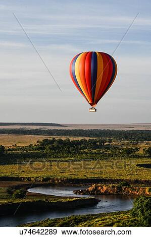 Air balloon floating over Mara River, Kenya View Large Photo Image Stock Photo - Air balloon floating over Mara River, Kenya. Fotosearch