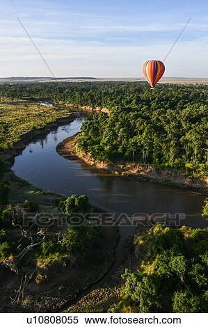 Stock Photography - Air balloon floating over Mara River, Kenya. Fotosearch
