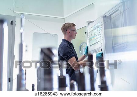 Ap0entice engineer at controls of CNC machine in gearbox factory View Large Photo Image Stock Image - Ap0entice engineer at controls of CNC machine in gearbox factory. Fotosearch