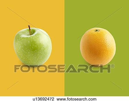 Apple and orange against yellow and green background. View Large Photo Image Stock Image - Apple and orange against yellow and green background.. Fotosearch