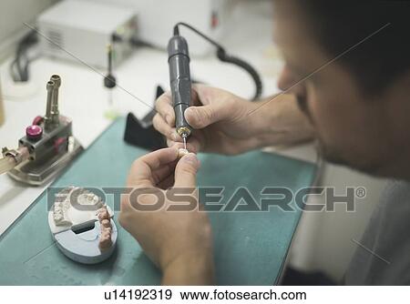 Artificial tooth and dental prosthesis being made. View Large Photo Image Stock Photo - Artificial tooth and dental prosthesis being made.. Fotosearch