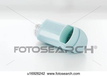 Stock Image - Asthma inhaler against a white background.. Fotosearch