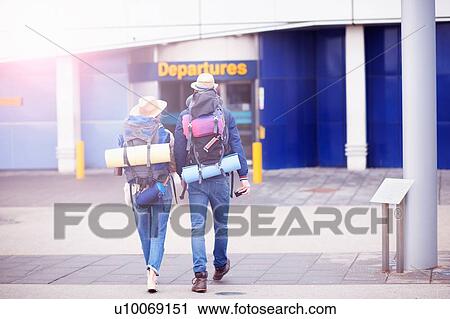 Backpacker couple entering airport View Large Photo Image Stock Image - Backpacker couple entering airport. Fotosearch