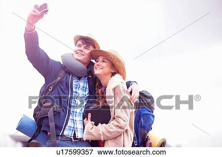 Backpacker couple taking selfie View Large Photo Image Stock Photo - Backpacker couple taking selfie. Fotosearch