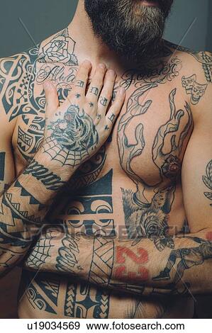 Bare chested young man, covered in tattoos, mid section View Large Photo Image Stock Photo - Bare chested young man, covered in tattoos, mid section. Fotosearch