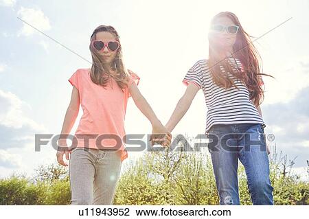 Best friends walking hand in hand View Large Photo Image Stock Image - Best friends walking hand in hand. Fotosearch