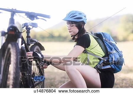 Picture - Biker stopping in park. Fotosearch