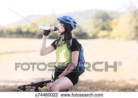 Biker stopping in park View Large Photo Image Stock Image - Biker stopping in park. Fotosearch