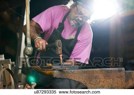Blacksmith working in his forge View Large Photo Image Stock Photography - Blacksmith working in his forge. Fotosearch