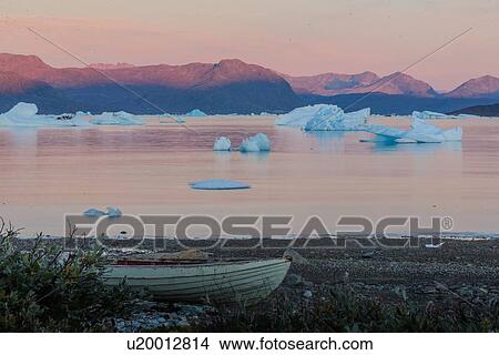 Picture - Boat on beach, icebergs and mountain ranges in background, Narsaq, Vestgronland, Greenland. Fotosearch