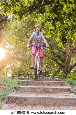 Boy cycling down steps in park View Large Photo Image Stock Photograph - Boy cycling down steps in park. Fotosearch