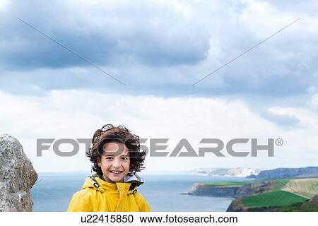 Boy on clifftop by sea, Bournemouth, UK View Large Photo Image Stock Image - Boy on clifftop by sea, Bournemouth, UK. Fotosearch