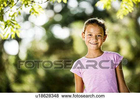 Stock Photo - Boy smiling in park, portrait.. Fotosearch