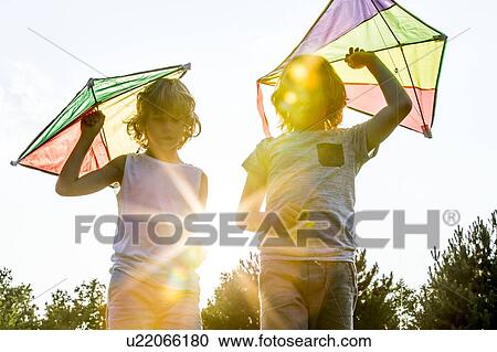 Boys holding kite in park. View Large Photo Image Stock Image - Boys holding kite in park.. Fotosearch